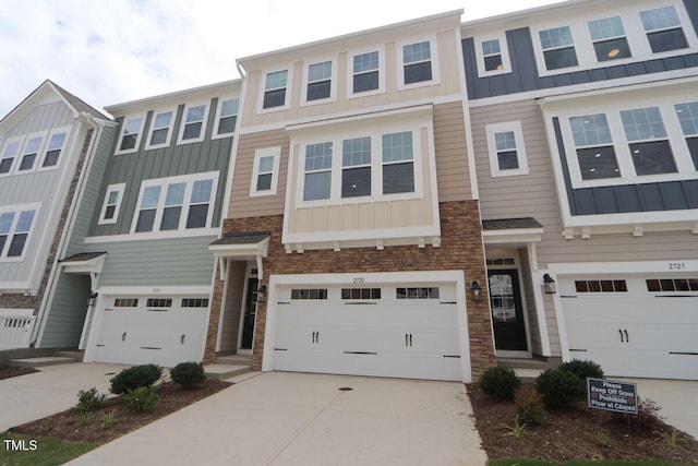 2721 Hunter Woods Dr # 565, Apex, NC 27502 - view of property with board and batten siding, driveway, stone siding, and a garage