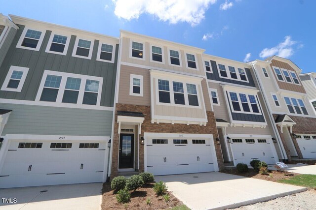 2721 Hunter Woods Dr # 565, Apex, NC 27502 - multi unit property with board and batten siding, an attached garage, and driveway