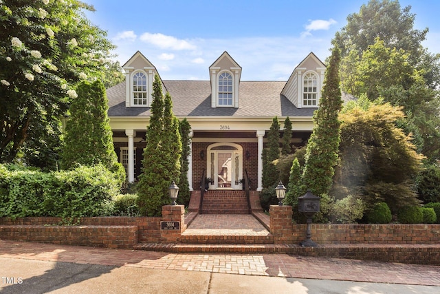 3604 Eden Croft Dr, Raleigh, NC 27612 - cape cod-style house featuring a porch, roof with shingles, and brick siding