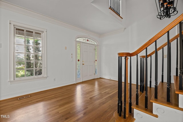 3604 Eden Croft Dr, Raleigh, NC 27612 - entrance foyer featuring plenty of natural light, wood finished floors, ornamental molding, and stairway