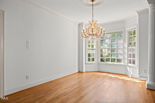 3604 Eden Croft Dr, Raleigh, NC 27612 - empty room featuring crown molding, wood finished floors, a chandelier, and ornate columns