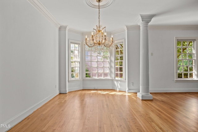 3604 Eden Croft Dr, Raleigh, NC 27612 - unfurnished dining area featuring decorative columns, light wood finished floors, a chandelier, and crown molding