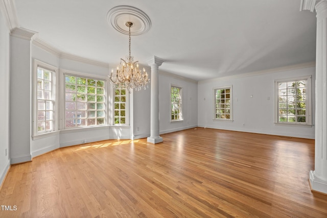 3604 Eden Croft Dr, Raleigh, NC 27612 - unfurnished living room with ornate columns, light wood-style flooring, a chandelier, and crown molding