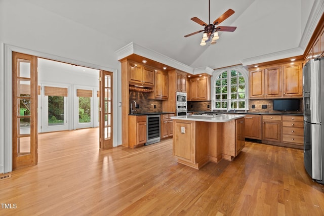 3604 Eden Croft Dr, Raleigh, NC 27612 - kitchen with light wood-type flooring, ceiling fan, vaulted ceiling, tasteful backsplash, and ornamental molding