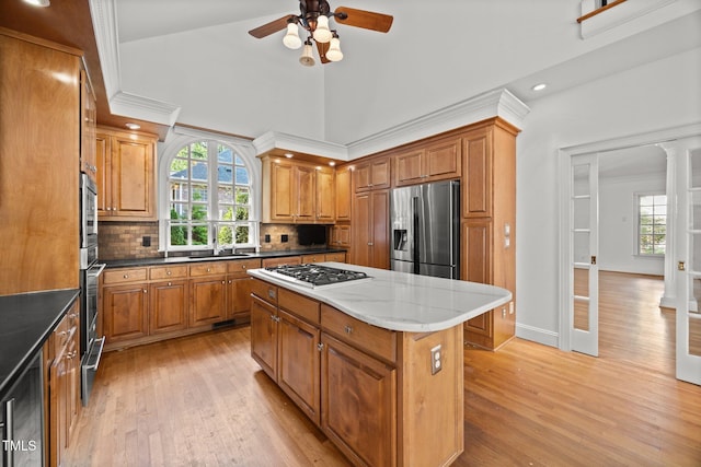3604 Eden Croft Dr, Raleigh, NC 27612 - kitchen featuring healthy amount of natural light, light wood-type flooring, brown cabinets, recessed lighting, and high vaulted ceiling