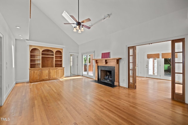 3604 Eden Croft Dr, Raleigh, NC 27612 - unfurnished living room with high vaulted ceiling, ceiling fan, a high end fireplace, and light wood-style flooring