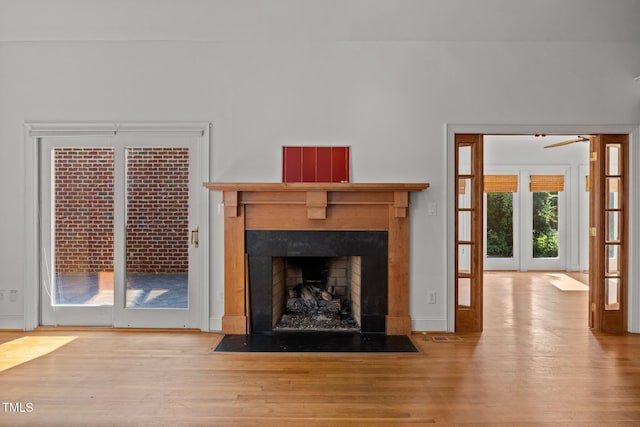 3604 Eden Croft Dr, Raleigh, NC 27612 - unfurnished living room with a fireplace with flush hearth, wood finished floors, and a ceiling fan