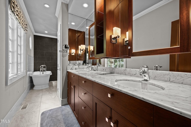 3604 Eden Croft Dr, Raleigh, NC 27612 - full bath with ornamental molding, double vanity, marble look tiles, a freestanding bath, and recessed lighting