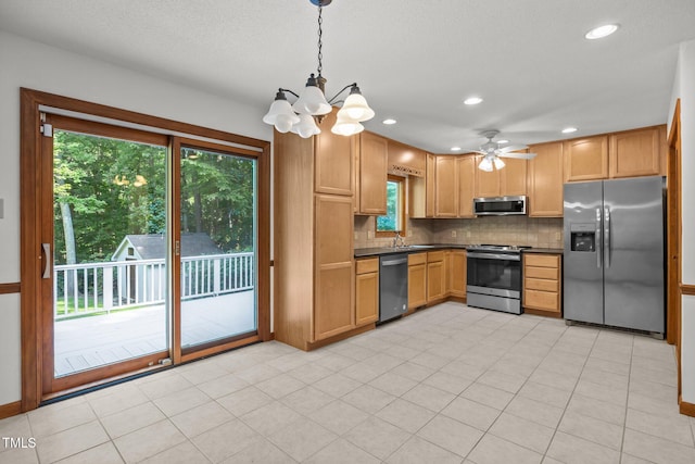 12501 Hardee Rd, Raleigh, NC 27614 - kitchen featuring appliances with stainless steel finishes, dark countertops, backsplash, a chandelier, and decorative light fixtures