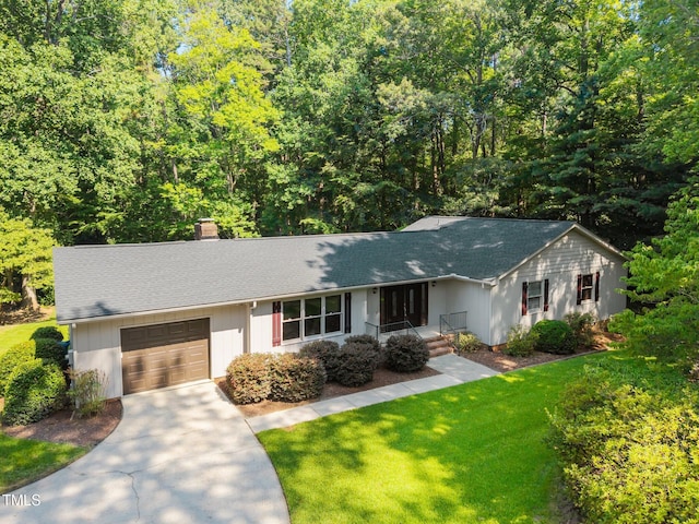 12501 Hardee Rd, Raleigh, NC 27614 - ranch-style house featuring an attached garage, a chimney, concrete driveway, a front yard, and a shingled roof
