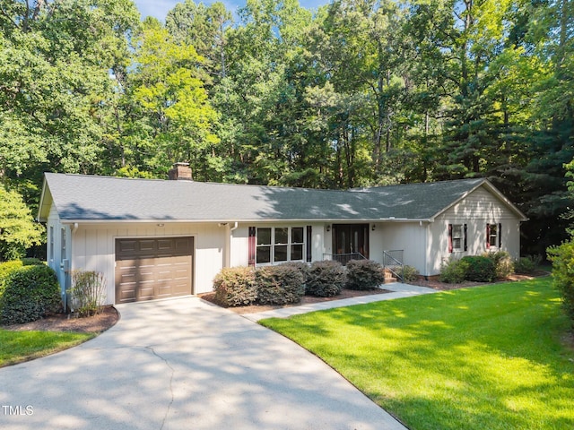 12501 Hardee Rd, Raleigh, NC 27614 - ranch-style house with a garage, concrete driveway, a chimney, and a front yard