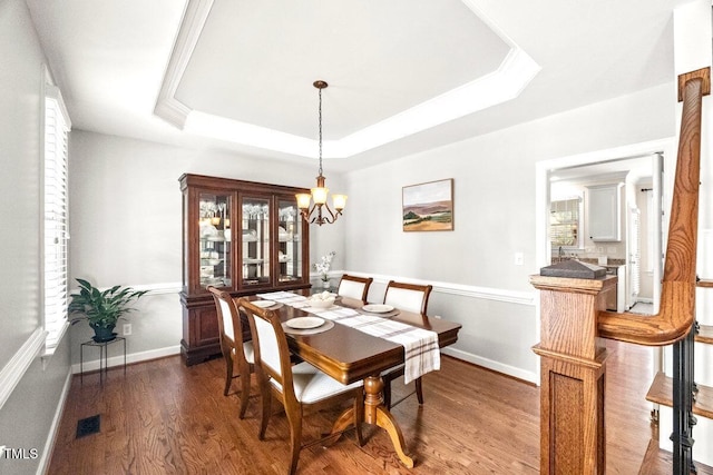 102 Barometer Ln, Cary, NC 27513 - dining room featuring a chandelier, wood finished floors, and a tray ceiling