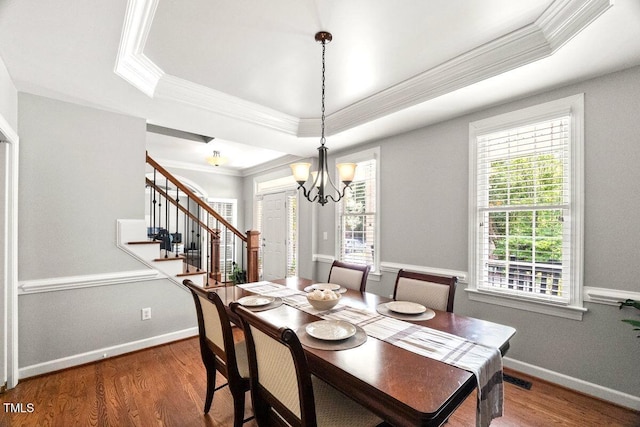 102 Barometer Ln, Cary, NC 27513 - dining area featuring a raised ceiling, crown molding, a chandelier, stairway, and wood finished floors