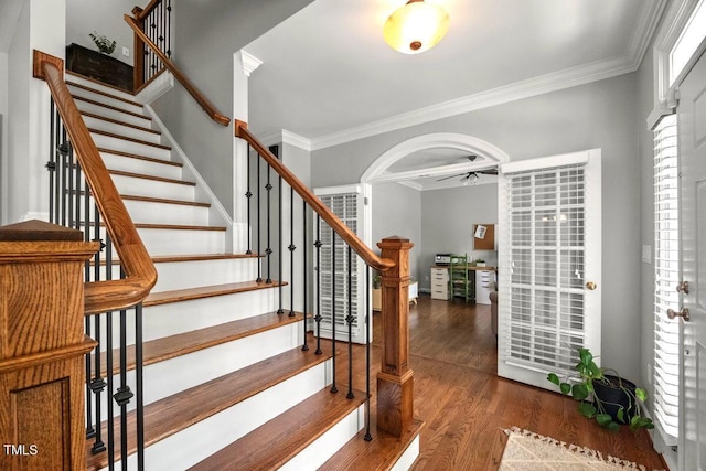 102 Barometer Ln, Cary, NC 27513 - stairway featuring crown molding, wood finished floors, ceiling fan, and arched walkways