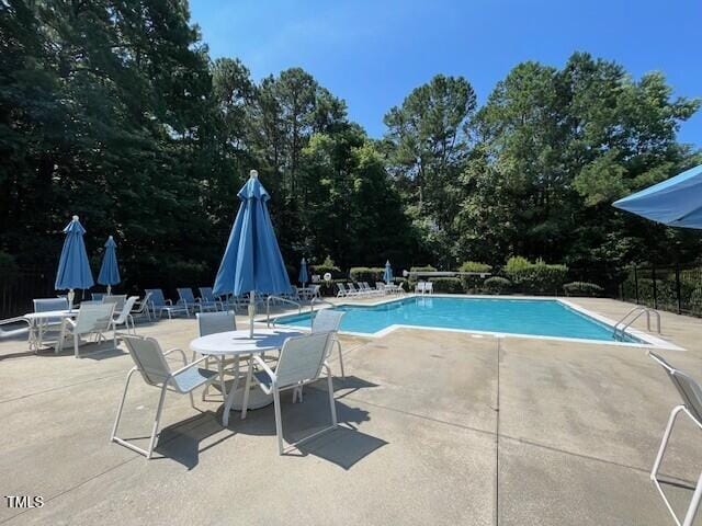 4032 Brook Cross Dr, Apex, NC 27539 - community pool with a patio and view of scattered trees