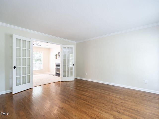 4032 Brook Cross Dr, Apex, NC 27539 - empty room with french doors, crown molding, dark wood-style flooring, and a fireplace with flush hearth