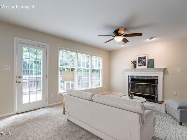 4032 Brook Cross Dr, Apex, NC 27539 - living room featuring a ceiling fan, plenty of natural light, a high end fireplace, and carpet