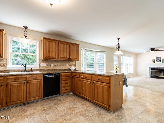4032 Brook Cross Dr, Apex, NC 27539 - kitchen with black dishwasher, brown cabinets, a high end fireplace, backsplash, and a peninsula