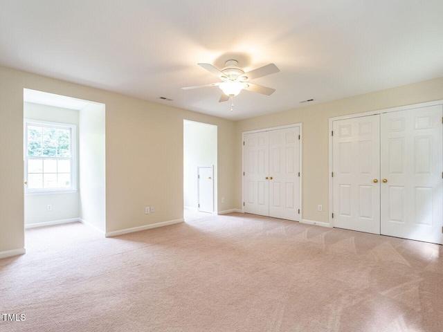 4032 Brook Cross Dr, Apex, NC 27539 - unfurnished bedroom with two closets, light colored carpet, and ceiling fan