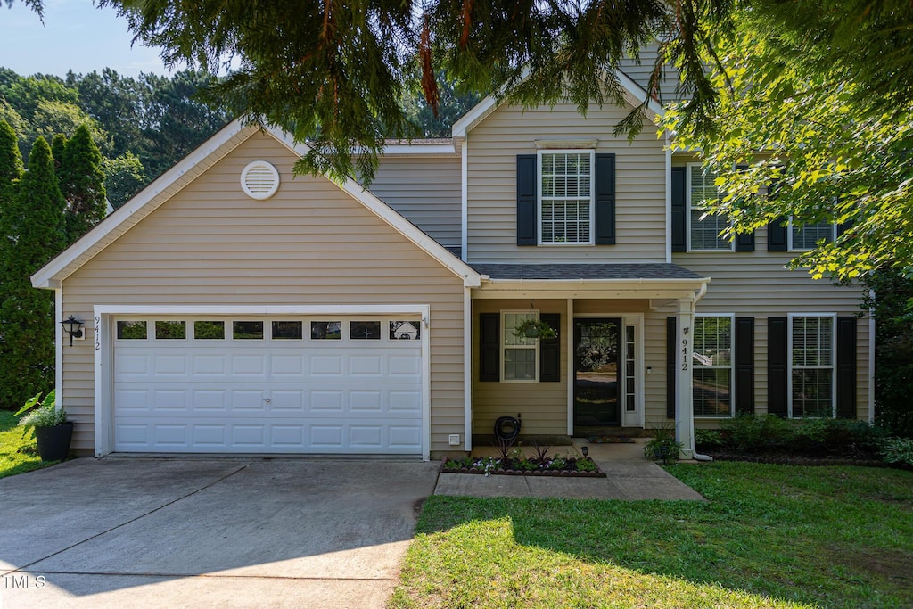 9412 Erinsbrook Dr, Raleigh, NC 27617 - traditional home featuring driveway, an attached garage, and a front yard