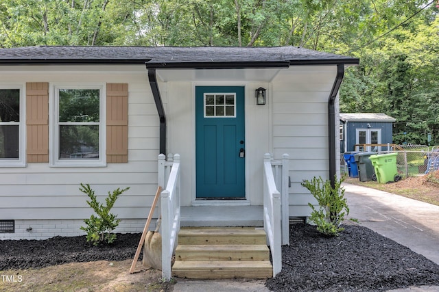 2408 Glascock St, Raleigh, NC 27610 - doorway to property featuring a shingled roof and crawl space