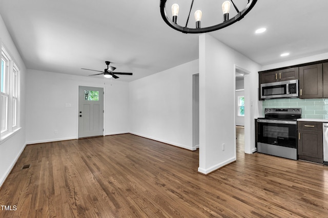 2408 Glascock St, Raleigh, NC 27610 - unfurnished living room featuring dark wood-style flooring, a ceiling fan, and recessed lighting