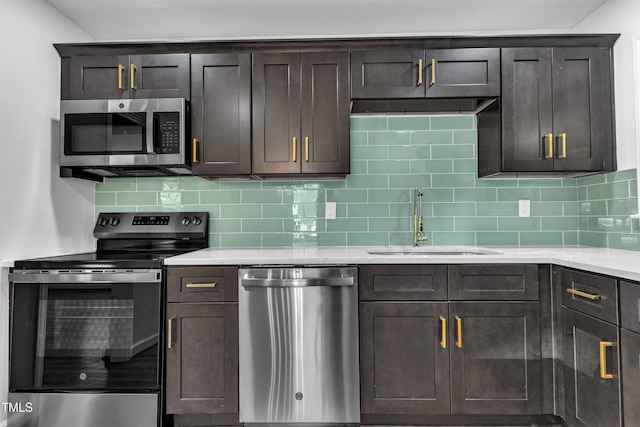 2408 Glascock St, Raleigh, NC 27610 - kitchen with stainless steel appliances, dark brown cabinets, tasteful backsplash, and light countertops