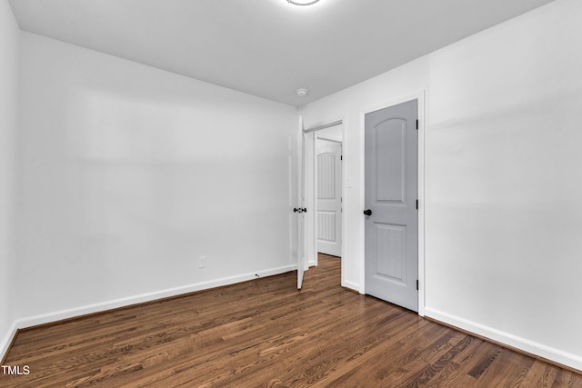 2408 Glascock St, Raleigh, NC 27610 - unfurnished bedroom featuring baseboards and dark wood-type flooring