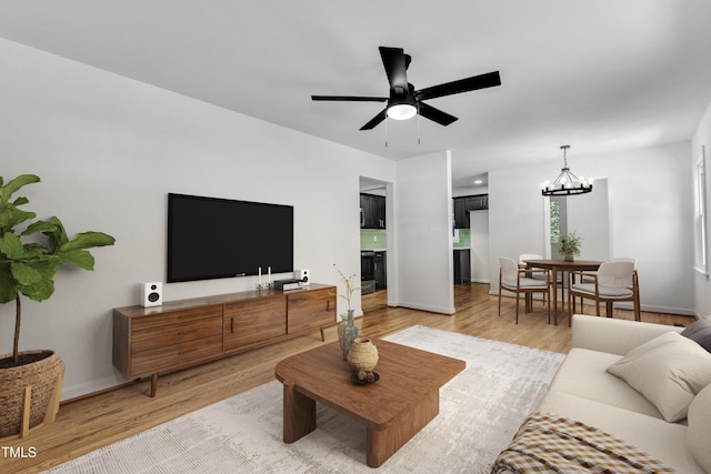 2408 Glascock St, Raleigh, NC 27610 - living room featuring a chandelier, light wood-style floors, and ceiling fan