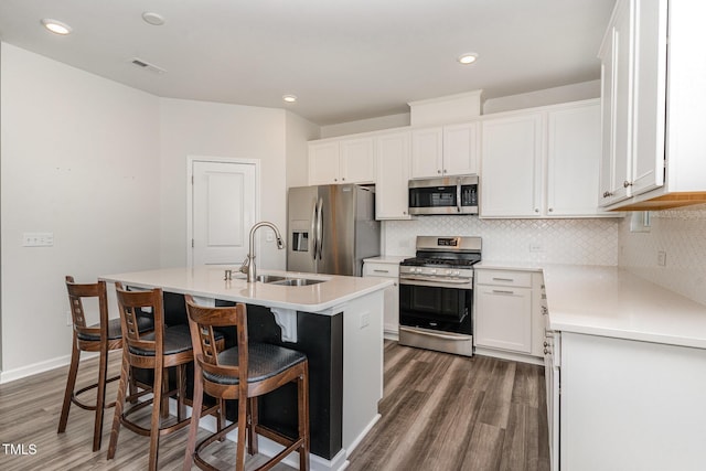 1425 Herb Garden Way, Apex, NC 27502 - kitchen with stainless steel appliances, wood finished floors, decorative backsplash, and recessed lighting