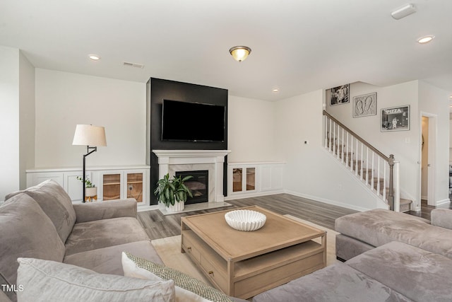 1425 Herb Garden Way, Apex, NC 27502 - living room featuring stairway, wood finished floors, recessed lighting, and a premium fireplace