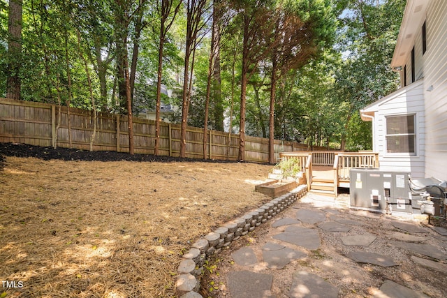 114 Dalmeny Dr, Cary, NC 27513 - fenced backyard featuring a deck and view of scattered trees