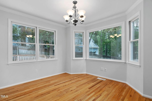 114 Dalmeny Dr, Cary, NC 27513 - empty room with plenty of natural light, a chandelier, wood finished floors, and crown molding