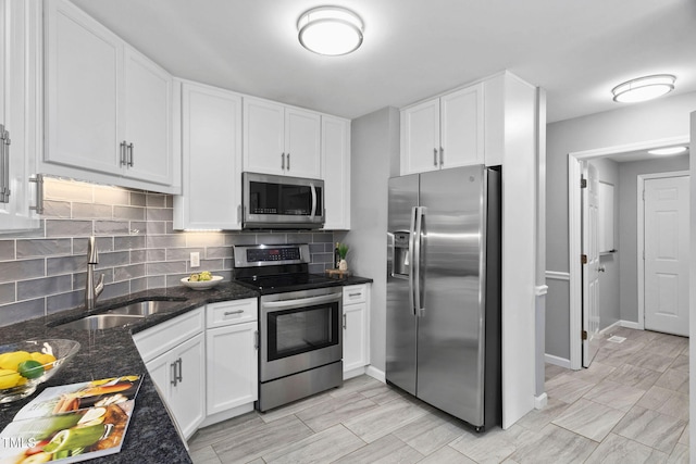 114 Dalmeny Dr, Cary, NC 27513 - kitchen featuring appliances with stainless steel finishes, tasteful backsplash, and white cabinetry