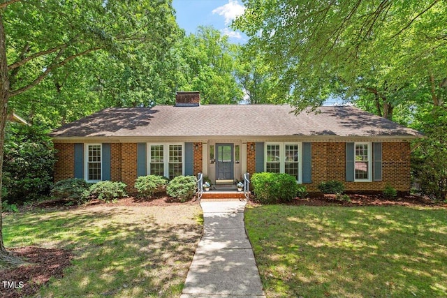 1920 Quail Ridge Rd, Raleigh, NC 27609 - ranch-style house with a front yard, brick siding, and a chimney