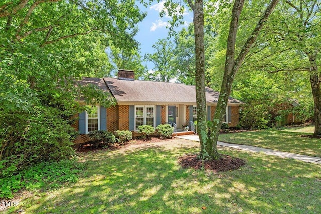 1920 Quail Ridge Rd, Raleigh, NC 27609 - ranch-style house with brick siding, a chimney, and a front yard