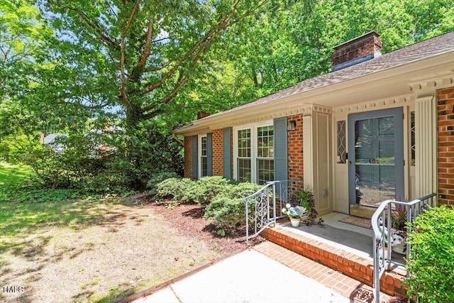 1920 Quail Ridge Rd, Raleigh, NC 27609 - property entrance featuring brick siding, a chimney, and roof with shingles