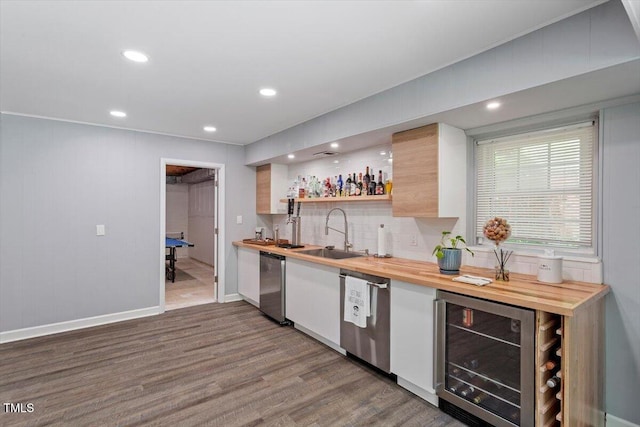 1920 Quail Ridge Rd, Raleigh, NC 27609 - indoor wet bar with beverage cooler, stainless steel dishwasher, wood finished floors, backsplash, and recessed lighting