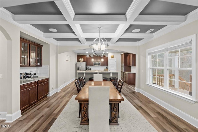 2981 Thurman Dairy, Wake Forest, NC 27587 - dining area with dark wood-style flooring, a chandelier, arched walkways, beam ceiling, and coffered ceiling