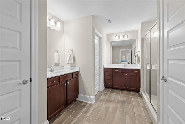 2981 Thurman Dairy, Wake Forest, NC 27587 - bathroom with vanity, a shower stall, and wood tiled floors