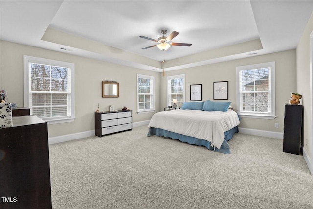 2981 Thurman Dairy, Wake Forest, NC 27587 - carpeted bedroom with a tray ceiling, multiple windows, and a ceiling fan