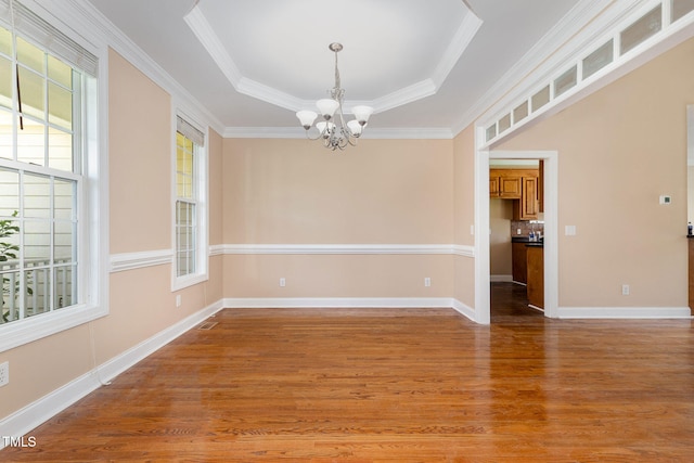 145 Adams Pointe Ct, Angier, NC 27501 - unfurnished room featuring a chandelier, plenty of natural light, wood finished floors, a raised ceiling, and ornamental molding