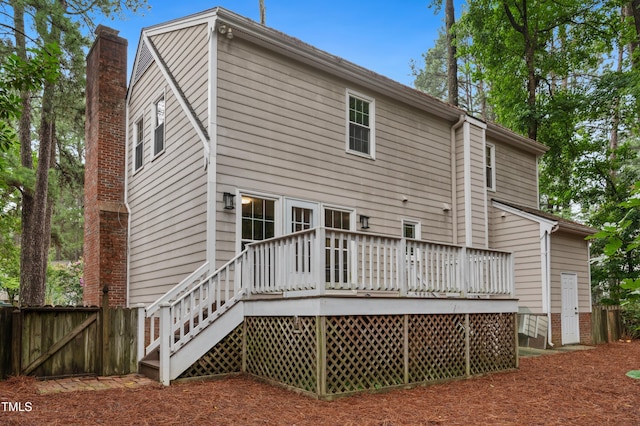 109 Grey Fox Ct, Cary, NC 27511 - back of house featuring a wooden deck, a chimney, and a gate