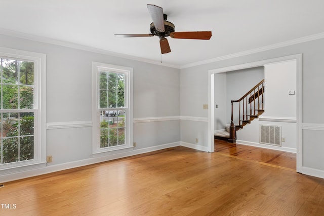 109 Grey Fox Ct, Cary, NC 27511 - empty room featuring plenty of natural light, light wood-style floors, stairs, ornamental molding, and ceiling fan