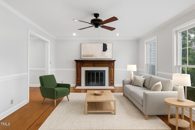 109 Grey Fox Ct, Cary, NC 27511 - living area featuring light wood-style flooring, crown molding, ceiling fan, a glass covered fireplace, and recessed lighting