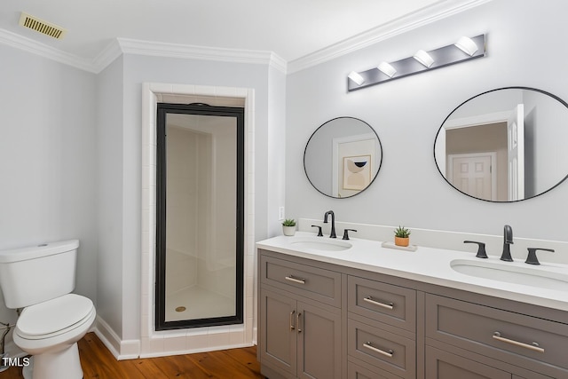 109 Grey Fox Ct, Cary, NC 27511 - bathroom featuring double vanity, crown molding, a shower stall, and wood finished floors
