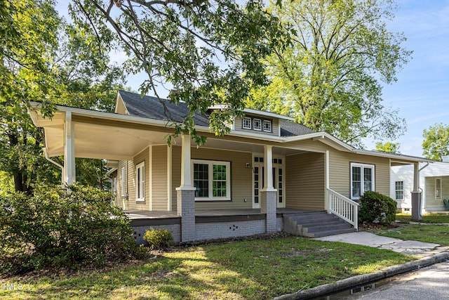 112 N Sellers St, Selma, NC 27576 - view of front of house with a porch, a front yard, and a shingled roof