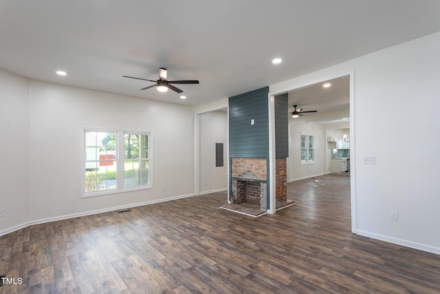 112 N Sellers St, Selma, NC 27576 - unfurnished living room with ceiling fan, dark wood finished floors, recessed lighting, a multi sided fireplace, and electric panel