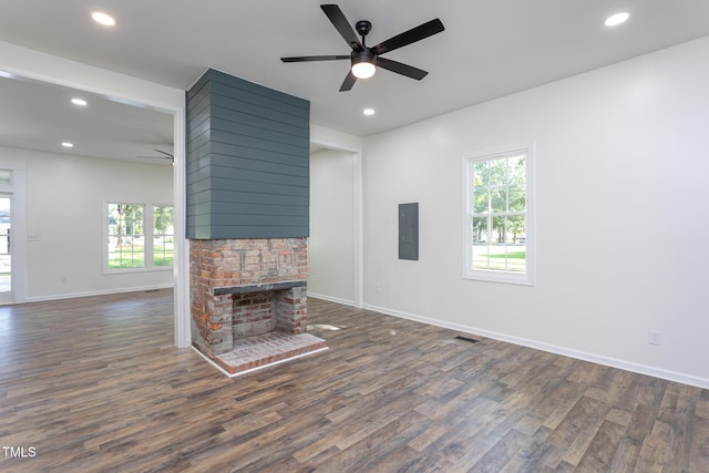 112 N Sellers St, Selma, NC 27576 - unfurnished living room with ceiling fan, electric panel, healthy amount of natural light, dark wood finished floors, and recessed lighting
