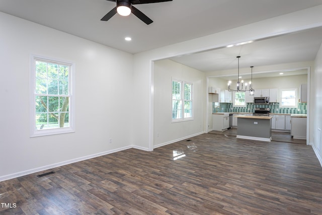 112 N Sellers St, Selma, NC 27576 - unfurnished living room featuring ceiling fan, dark wood-type flooring, a chandelier, and recessed lighting